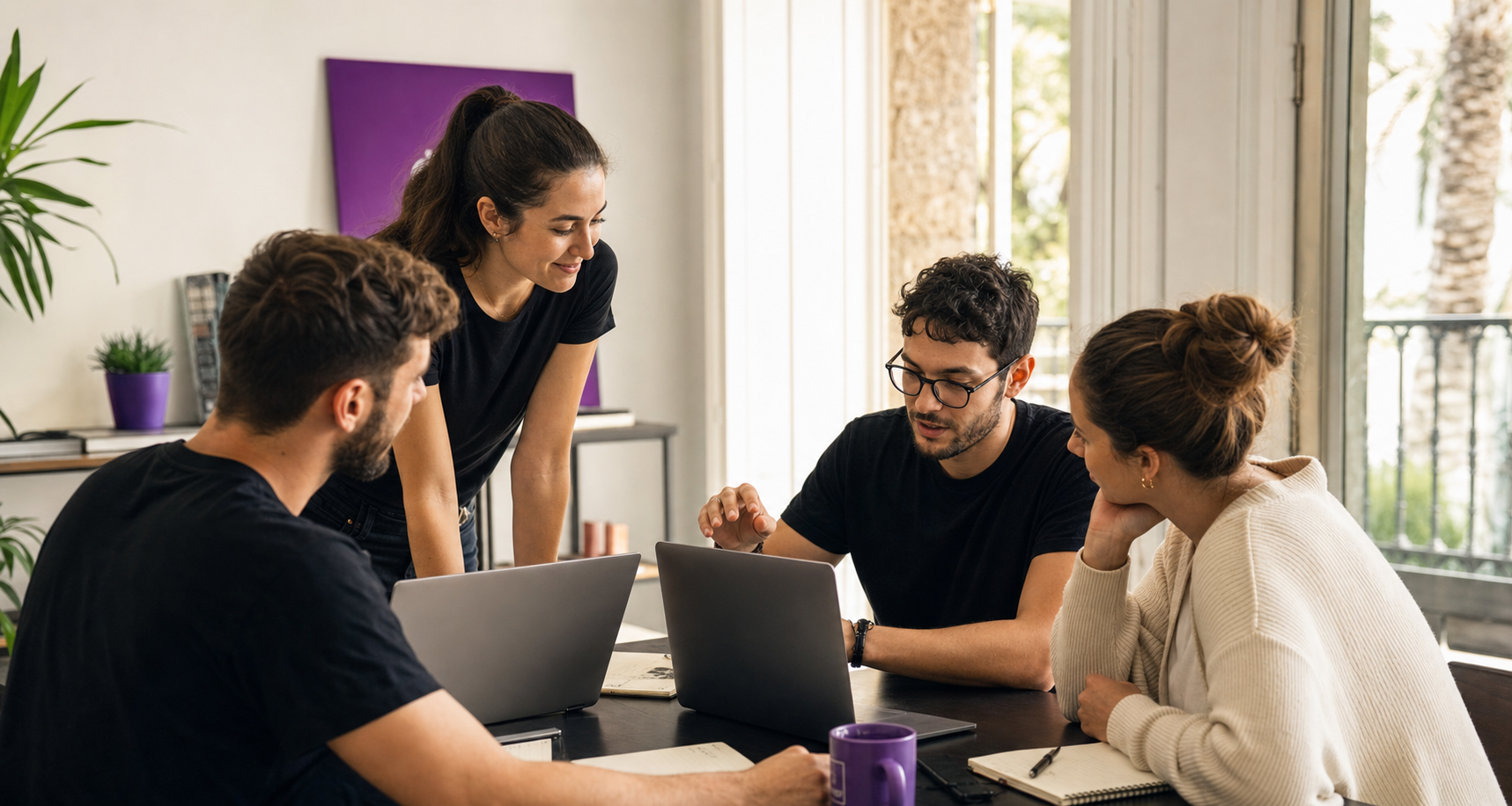 Team collaborating around a table in a bright office.